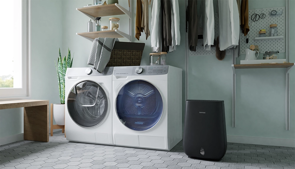 Family using a dehumidifier to help dry laundry indoors